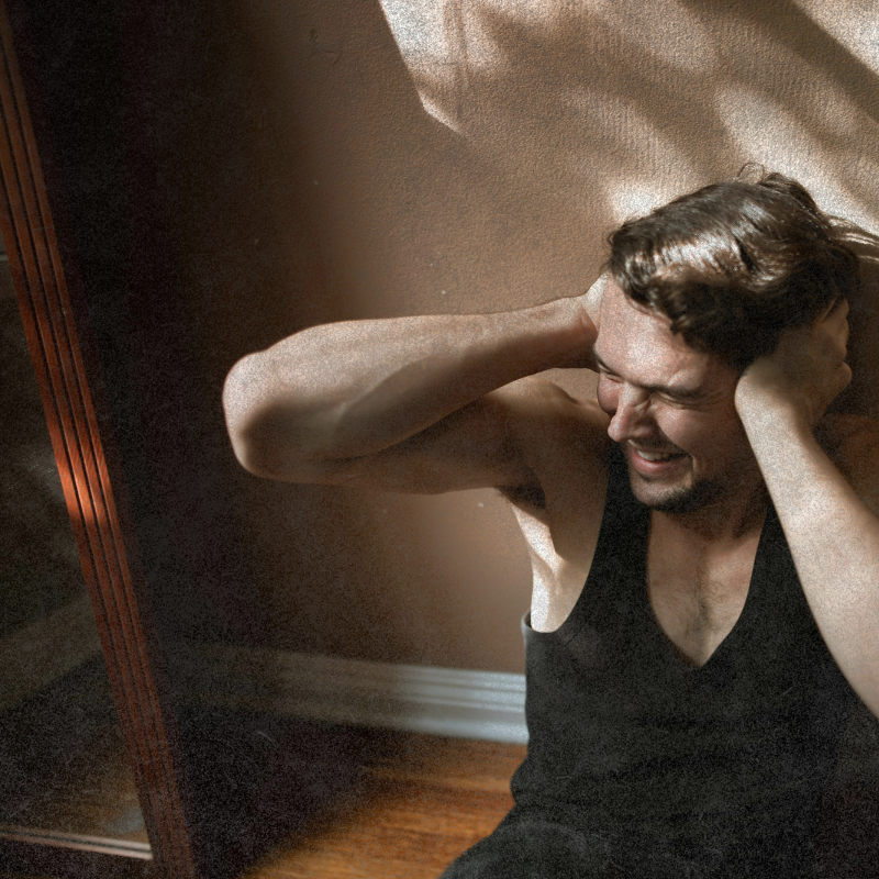 man covering his ears