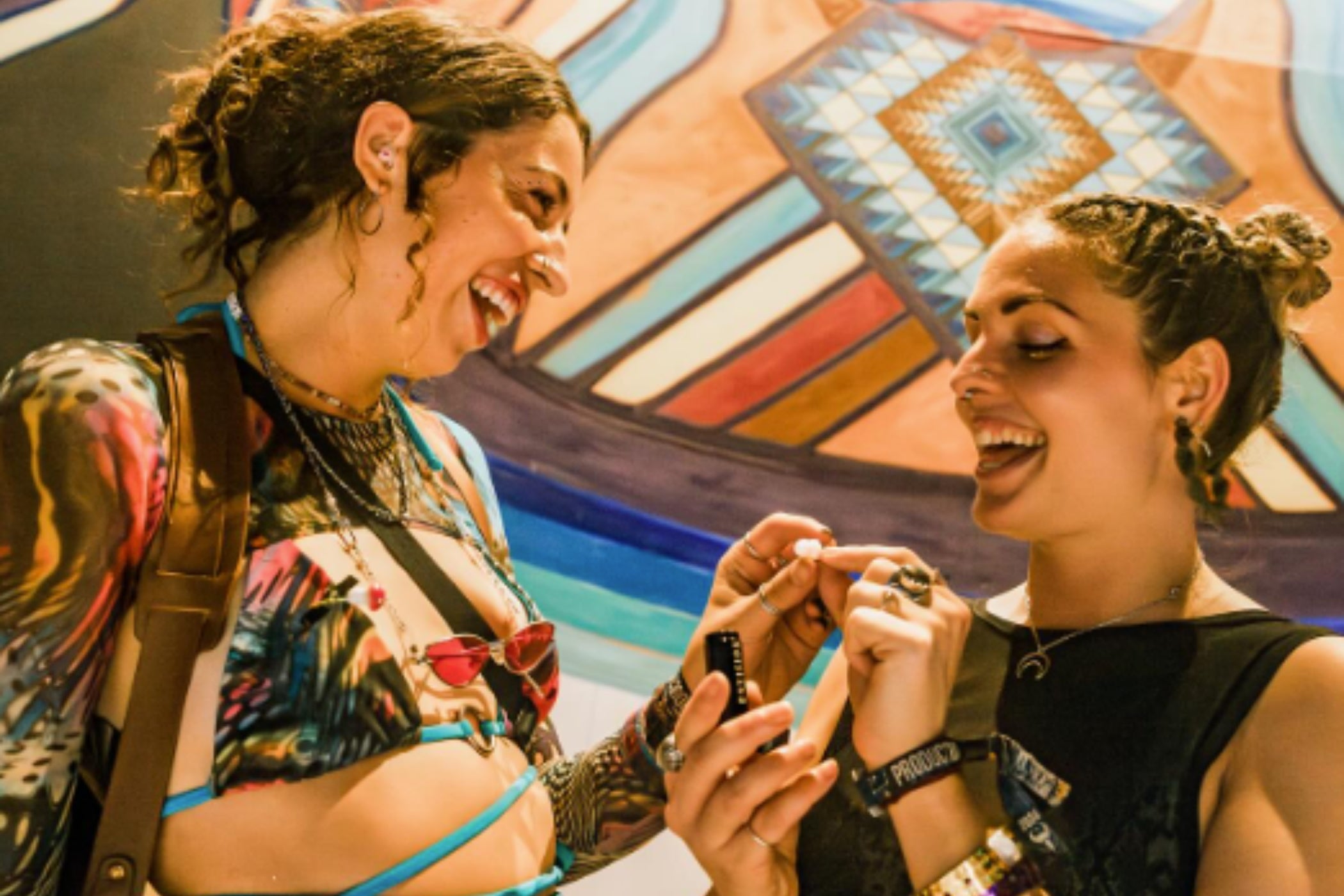 two friends and one is giving the other earplugs