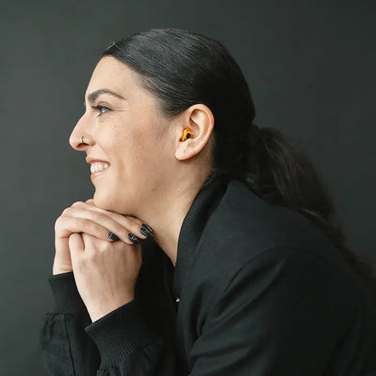 side view of model wearing Earpeace  Adventure PRO earplugs