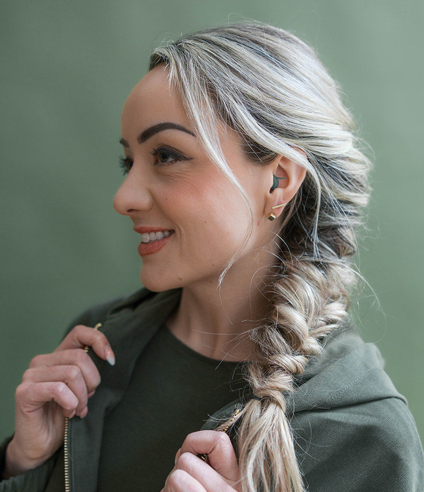 girl wearing earpeace everyday earplug in forest #color_forest